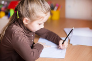 Young girl writing left handed